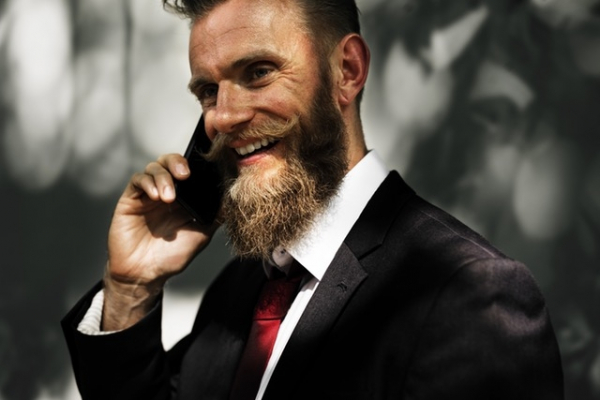 Man met baard met smartphone in hand